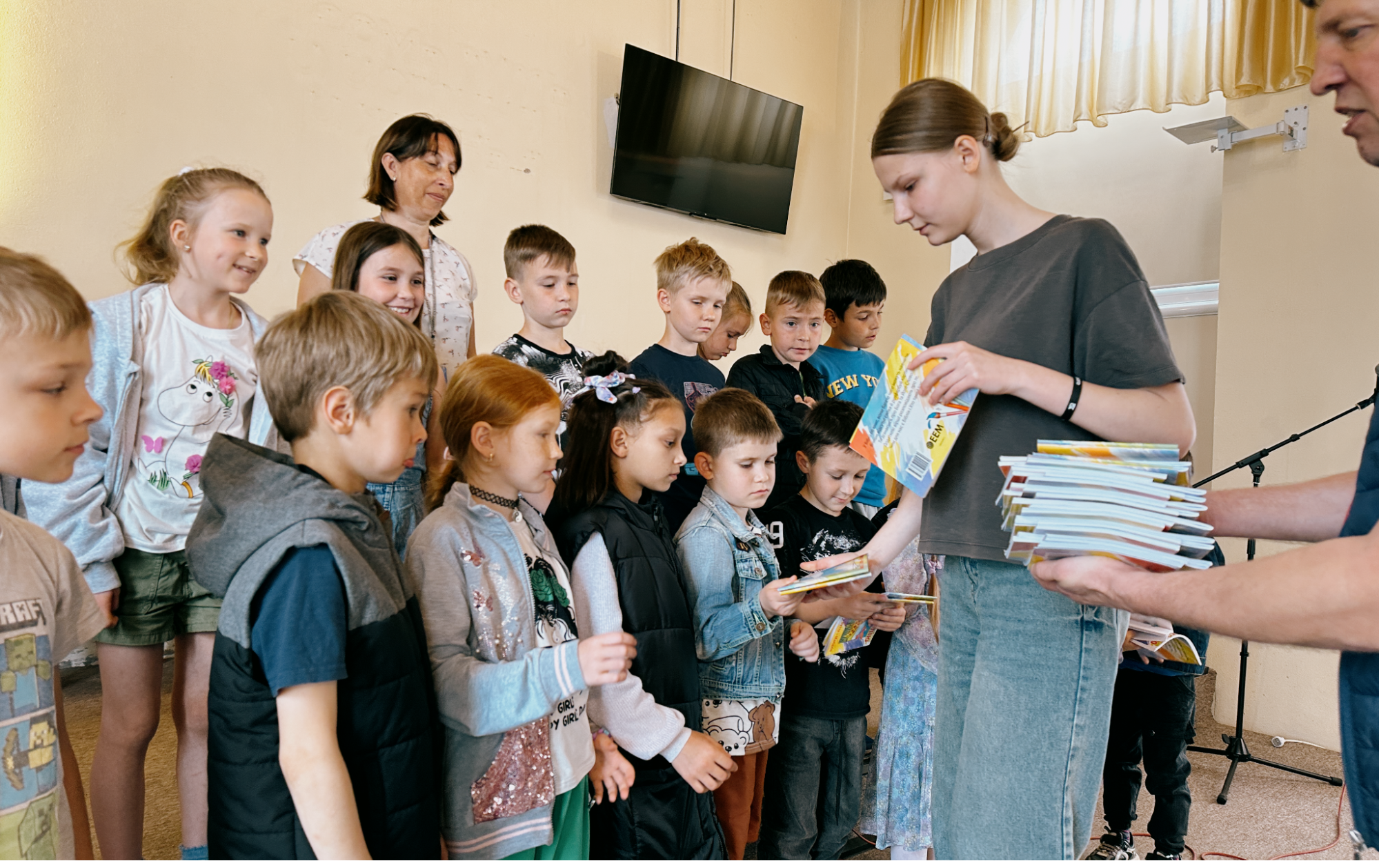 Children receiving EEM’s Bible-based activity and coloring books